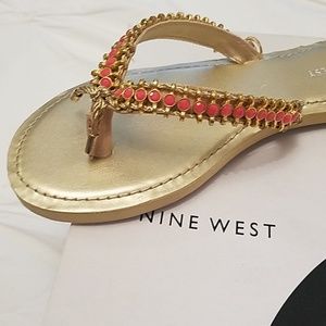 Nine West pink and gold flip flops.
